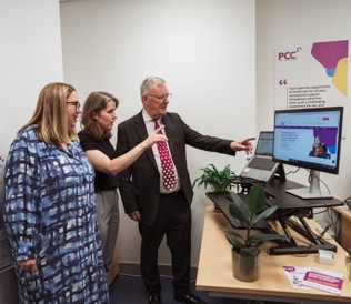 Minister Nesbitt with PCC Chief and Chair looking at new website